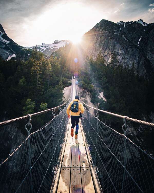 A man running across a bridge