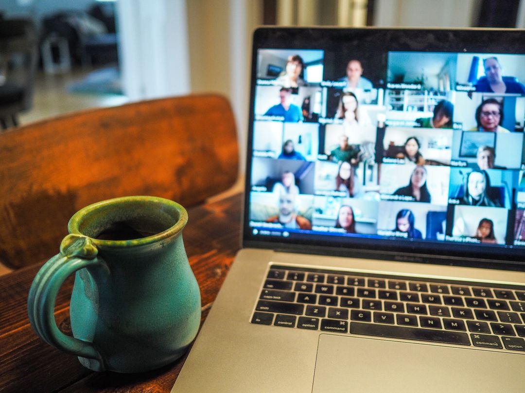 A laptop showing a zoom call with Waha community members